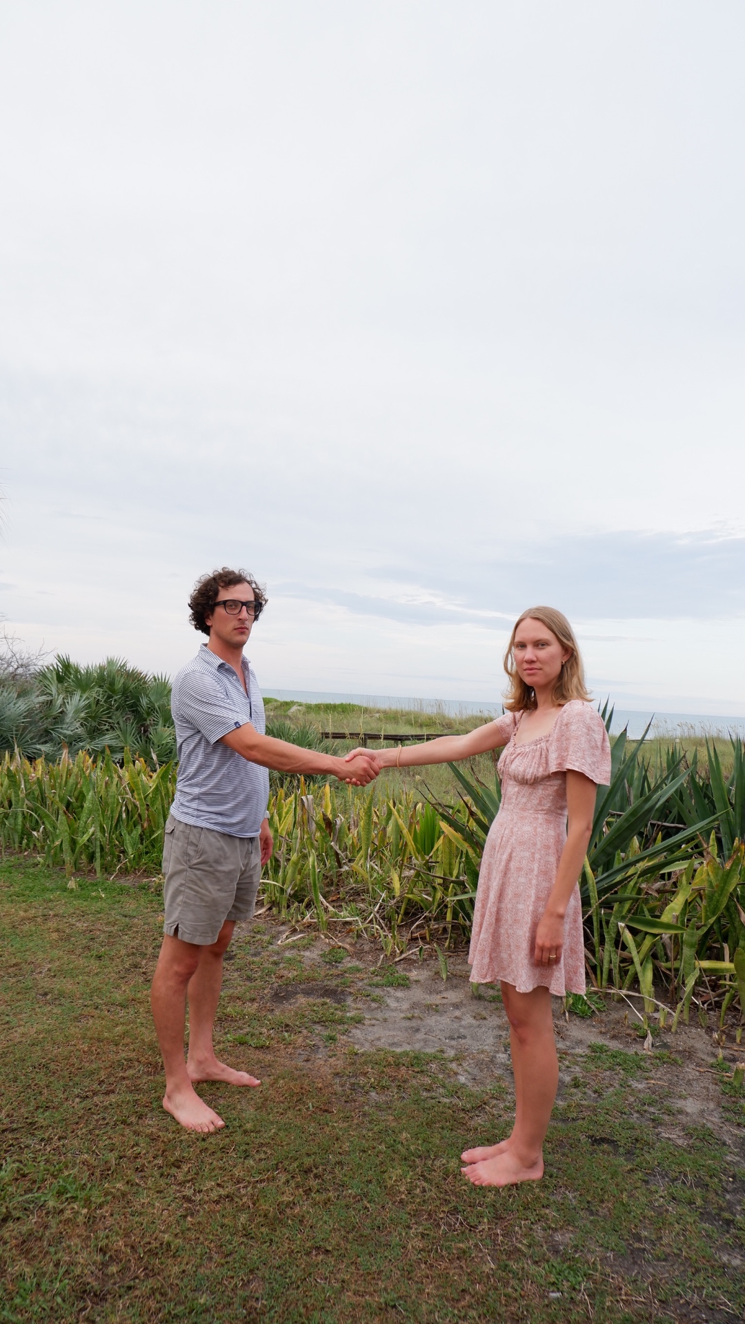 Blake and Josh sharing a handshake on the beach