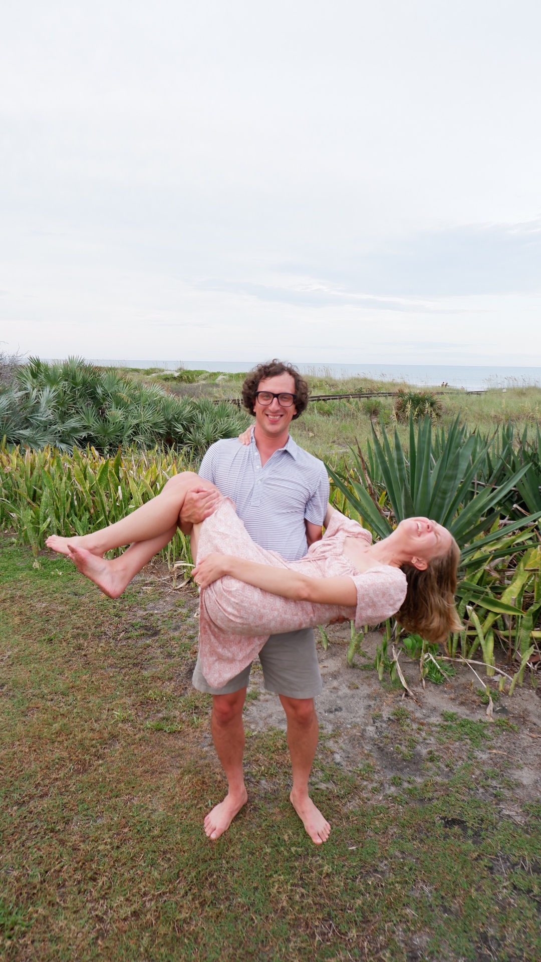 Josh sweeping Blake off her feet on the beach